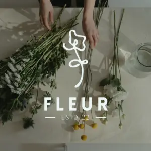 Fleur logo over hands arranging wildflowers, branding by Inversit