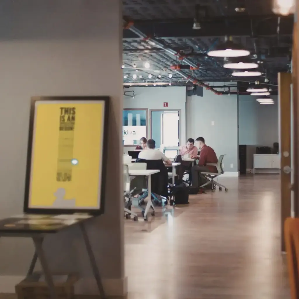 People working in an open-plan office, managed web hosting by Inversit